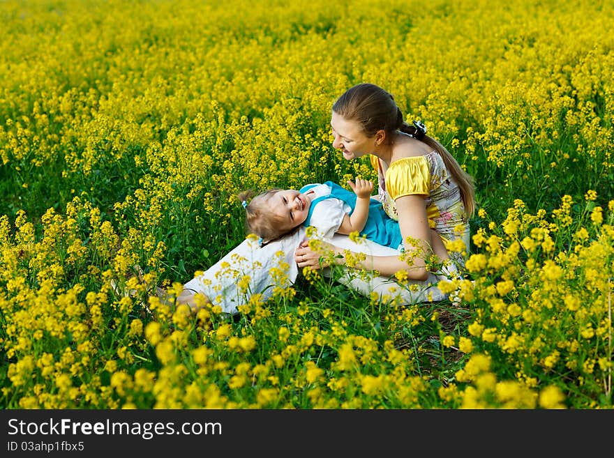 Mother with baby on yellow field