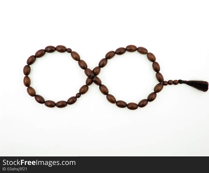 Cherrywood rosary in form of endlessness on the white background