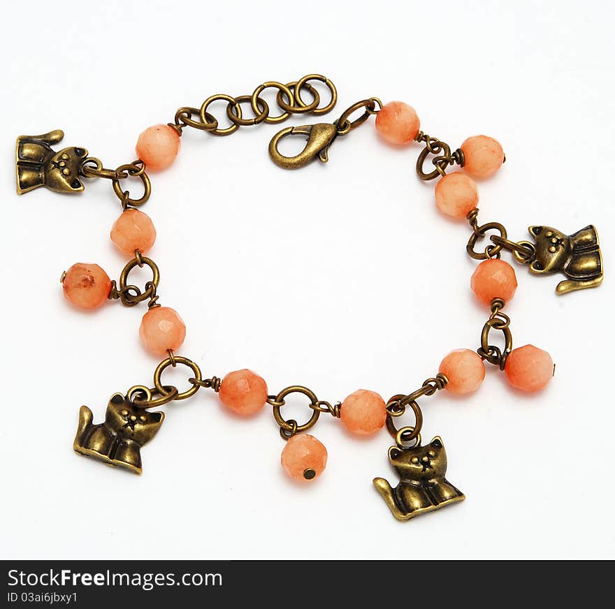 Beautiful bracelet made of coral on a bronze chain white background