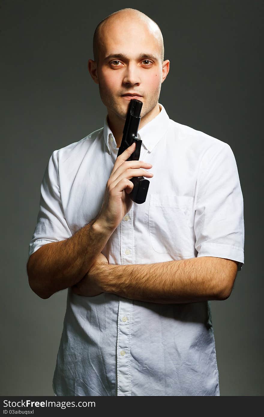 Portrait of a handsome young man holding a gun