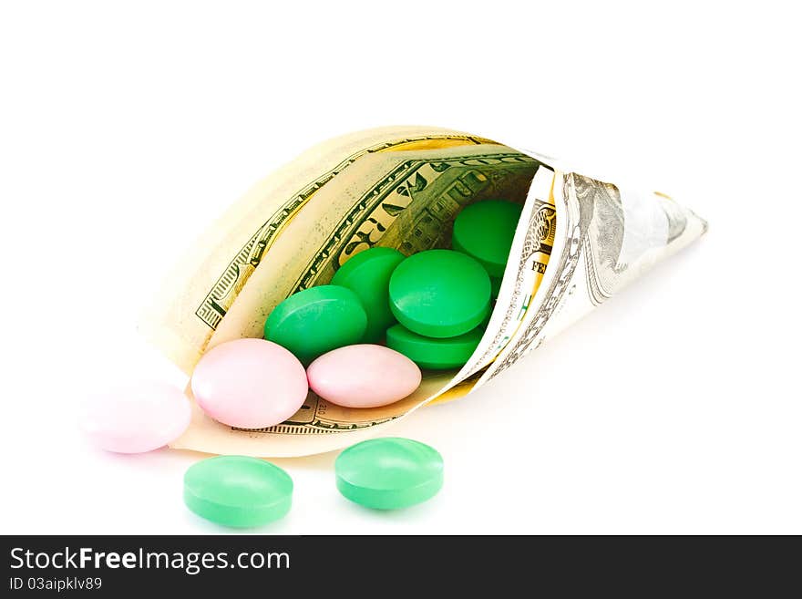 Colored tablets in monetary package is isolated on a white background. Colored tablets in monetary package is isolated on a white background