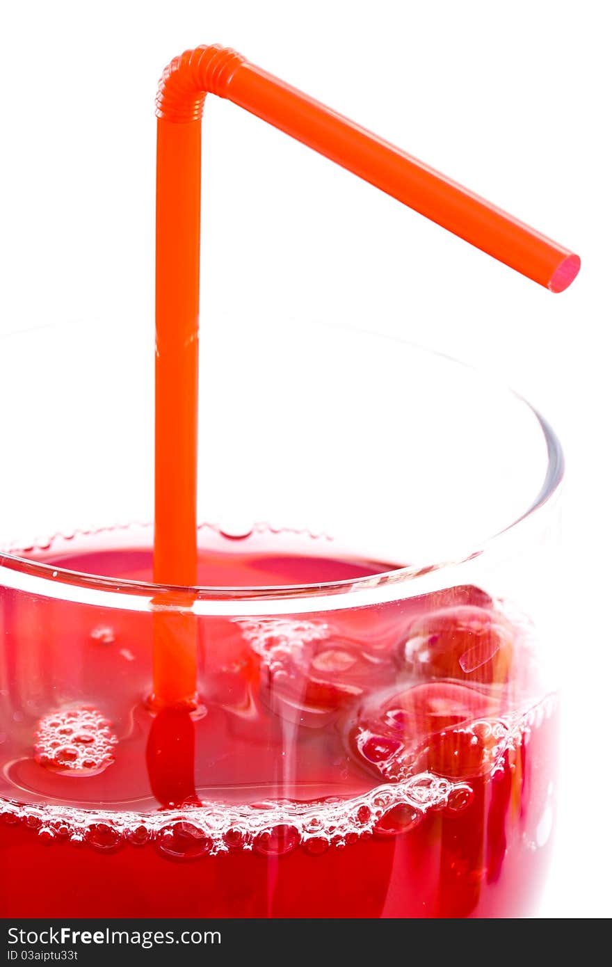 Fresh red berry compote in a glass on a white background