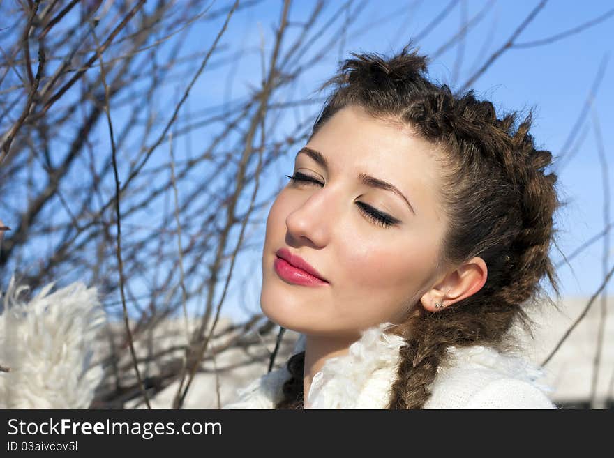 Outside portrait of beautiful young woman with eyes shut. Outside portrait of beautiful young woman with eyes shut