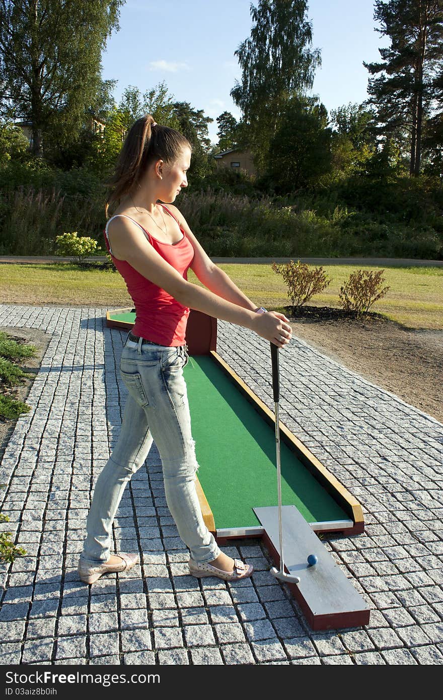 Young woman playing golf in a country club