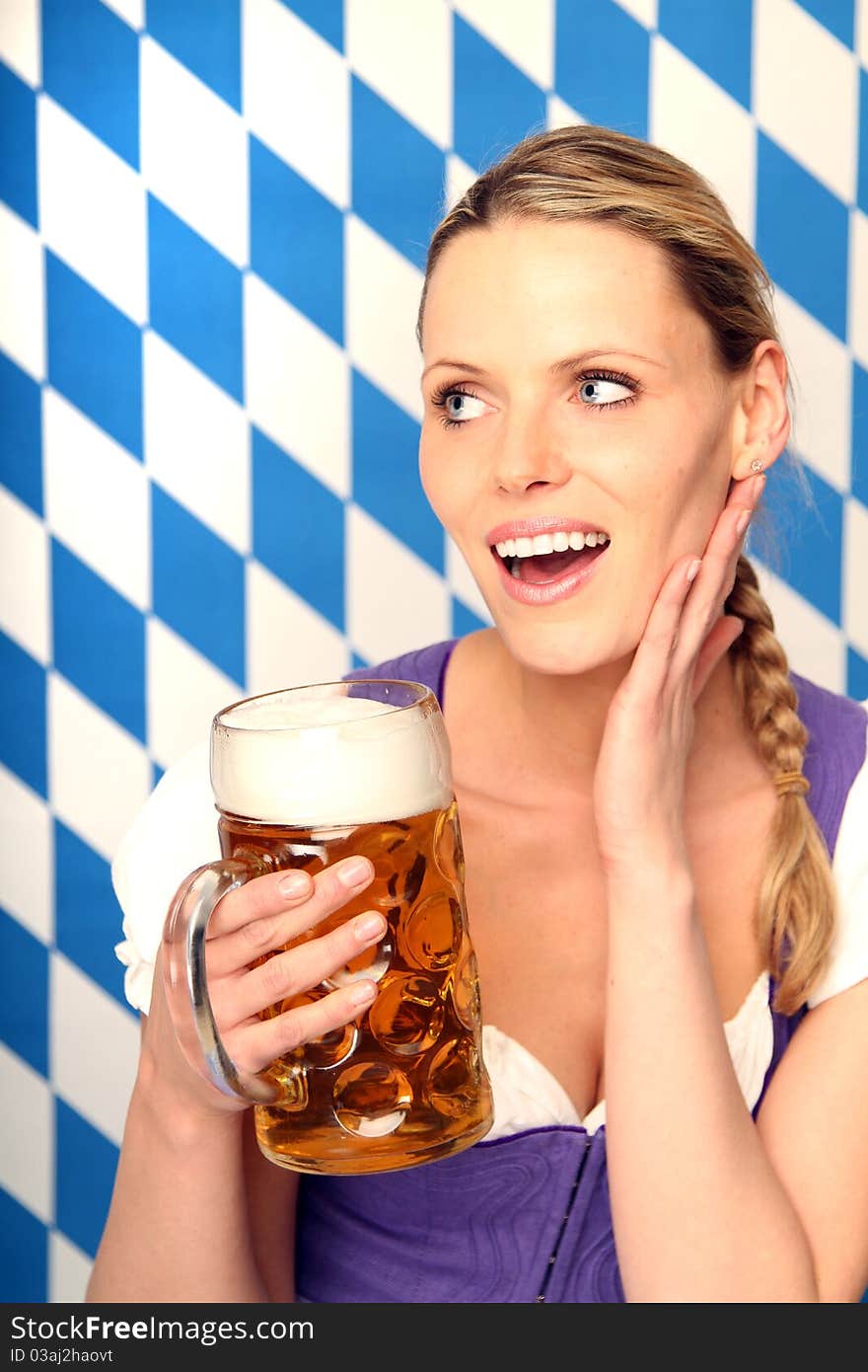 Woman in bavarian dress is holding her beer. Woman in bavarian dress is holding her beer