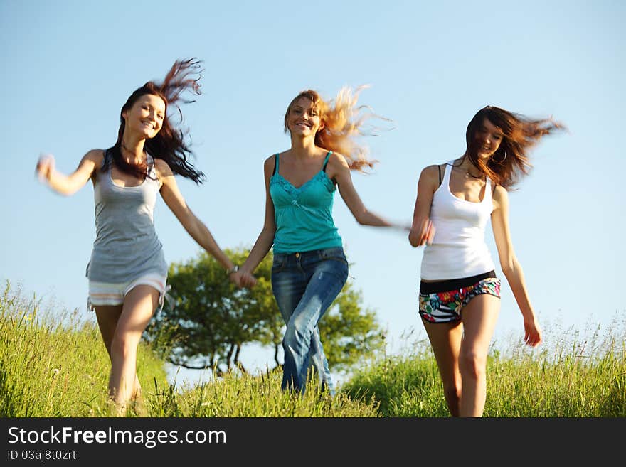 Fun smile girlfriends run by green field sun is shine. Fun smile girlfriends run by green field sun is shine