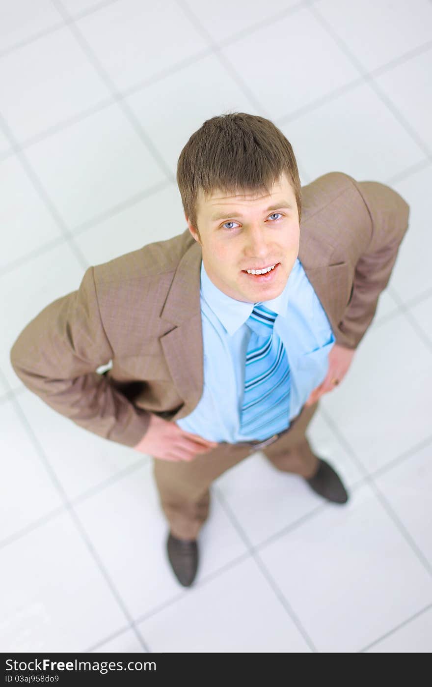 Happy businessman standing outside with arms outstretched