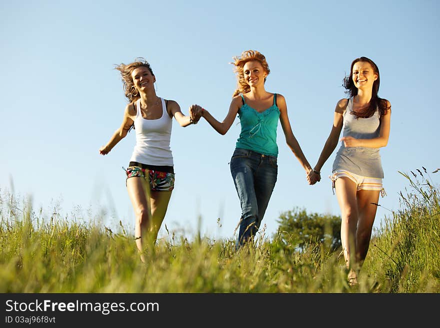 Fun smile girlfriends run by green field sun is shine. Fun smile girlfriends run by green field sun is shine