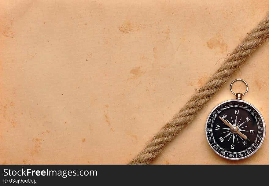 Compass and rope on old paper