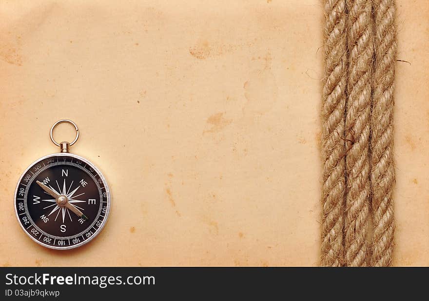 Compass and rope on old paper