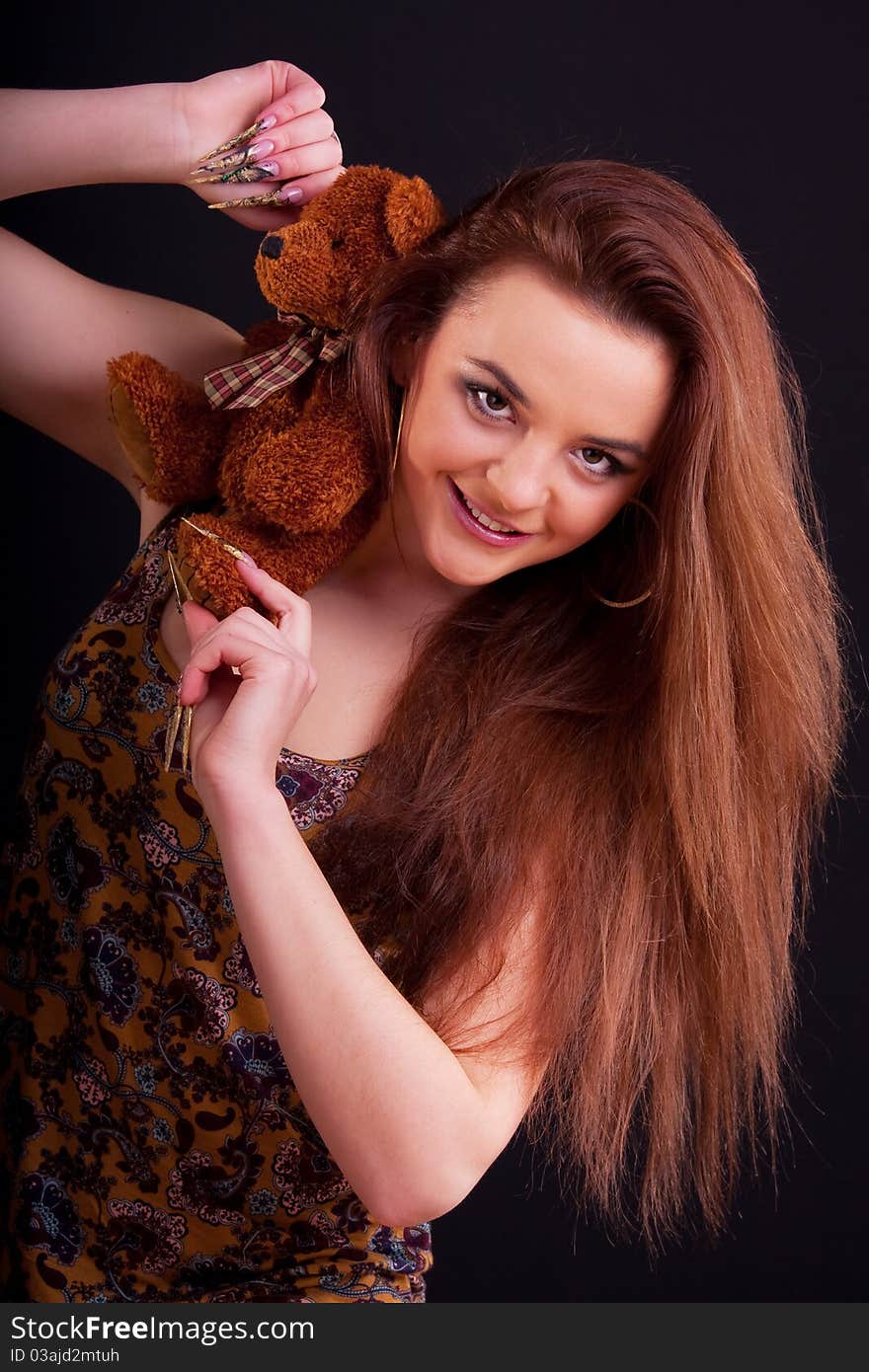 Beautiful longhair girl is holding the teddy bear. Beautiful longhair girl is holding the teddy bear