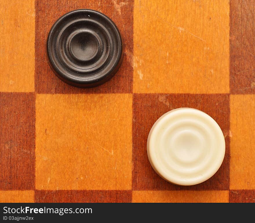 Checkers on old wood board. Checkers on old wood board