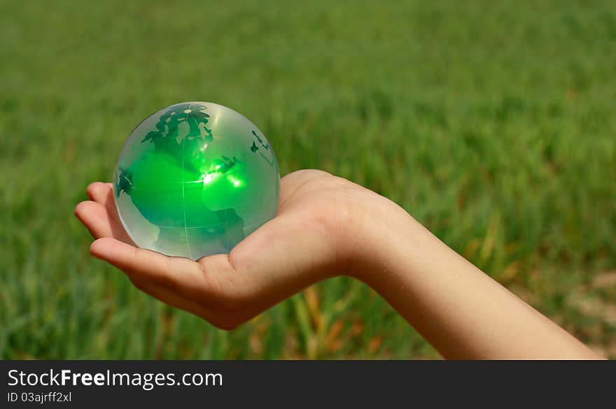 Glass ball in the hands of the planet