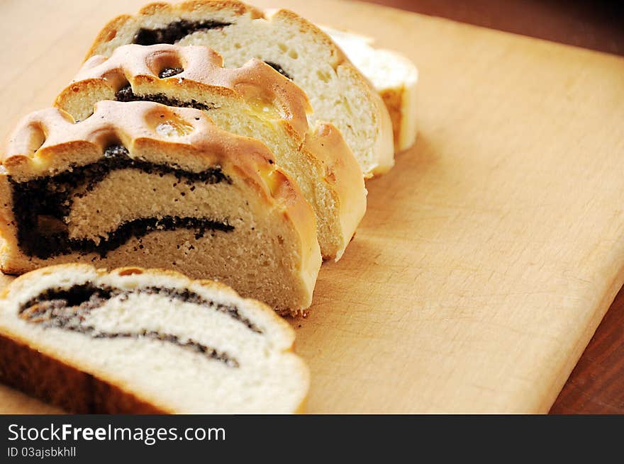 Fresh baked bread roll with poppy seeds