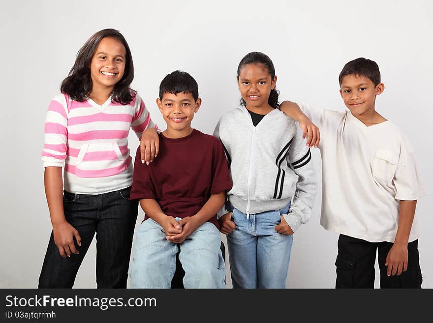 School friendship of four young happy, mixed race school children, two boys and two girls. School friendship of four young happy, mixed race school children, two boys and two girls.