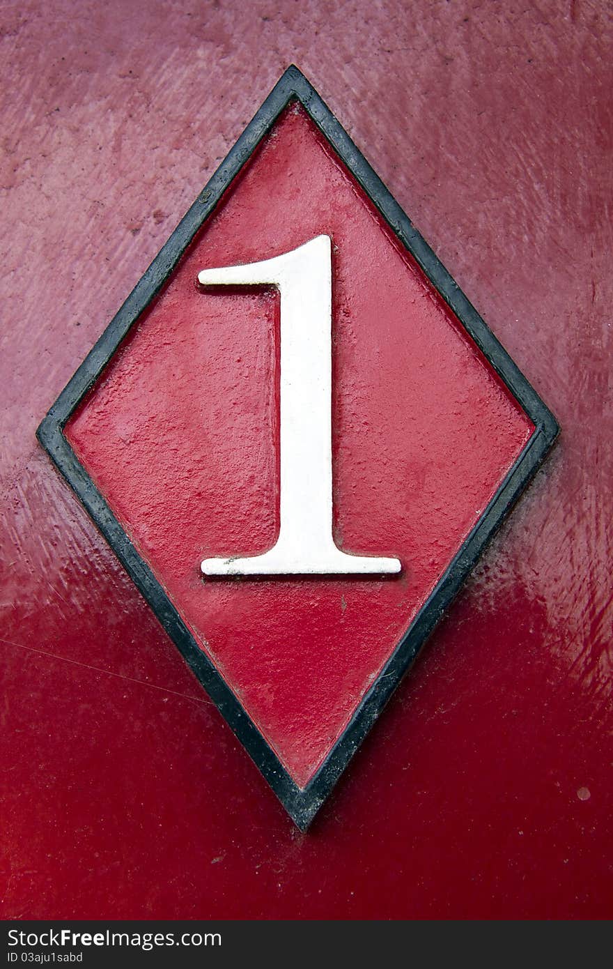 Weathered door number on red wood background. Weathered door number on red wood background