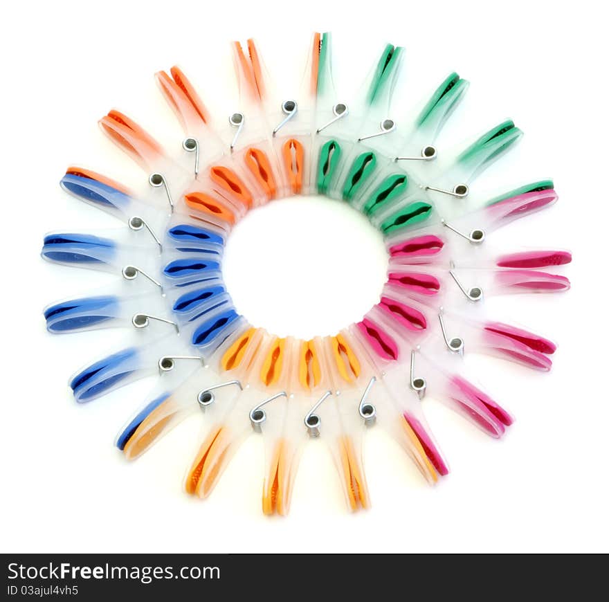 Colorful clothes-pegs on a white background. Colorful clothes-pegs on a white background