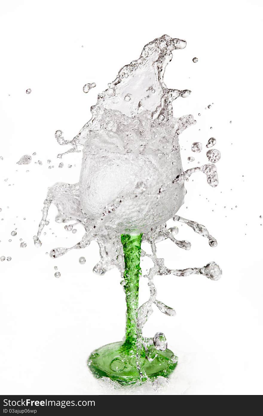 Water splashing out of a glass on white background