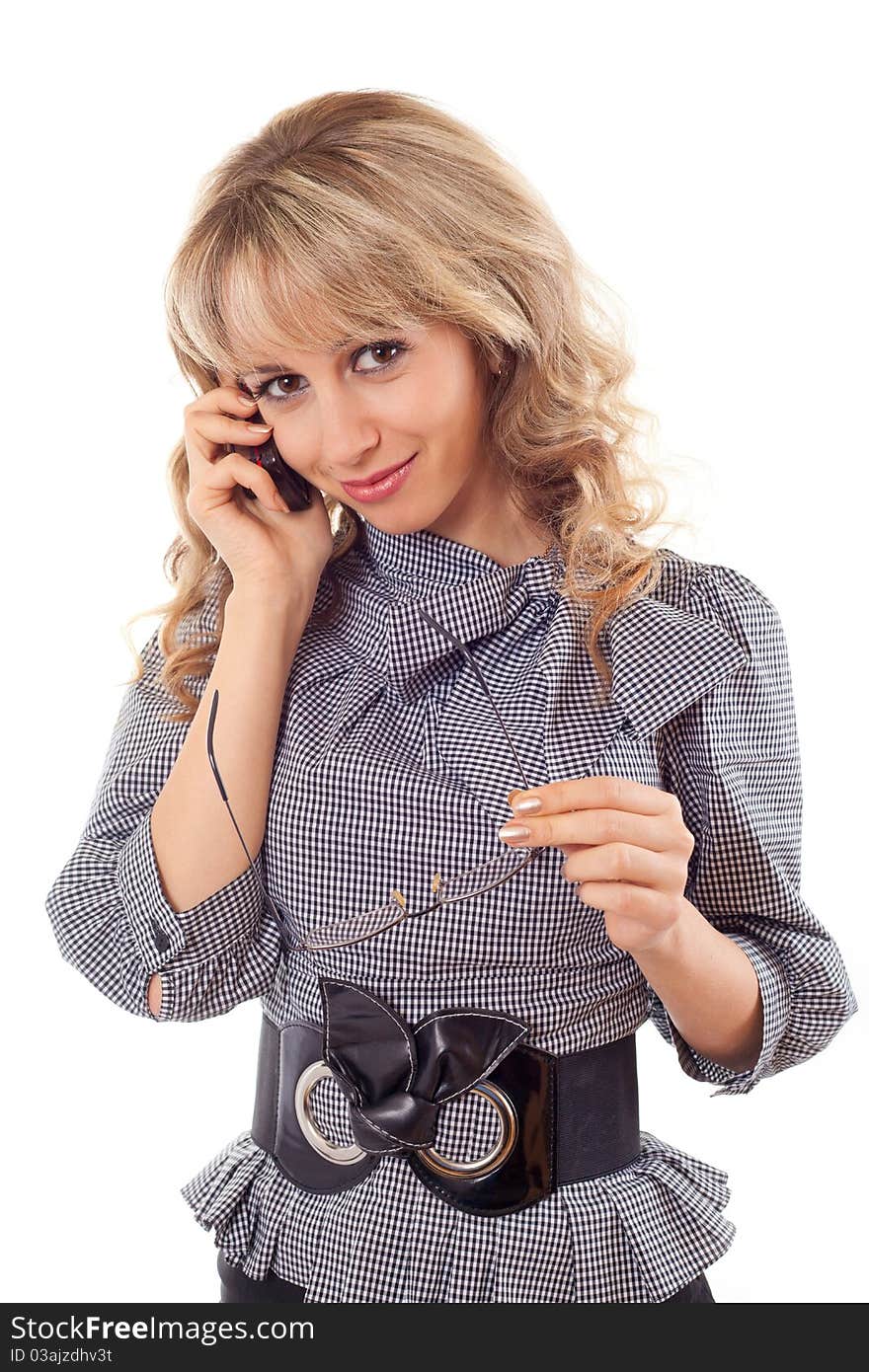 Portrait of a cute young girl talking on mobile phone against white background