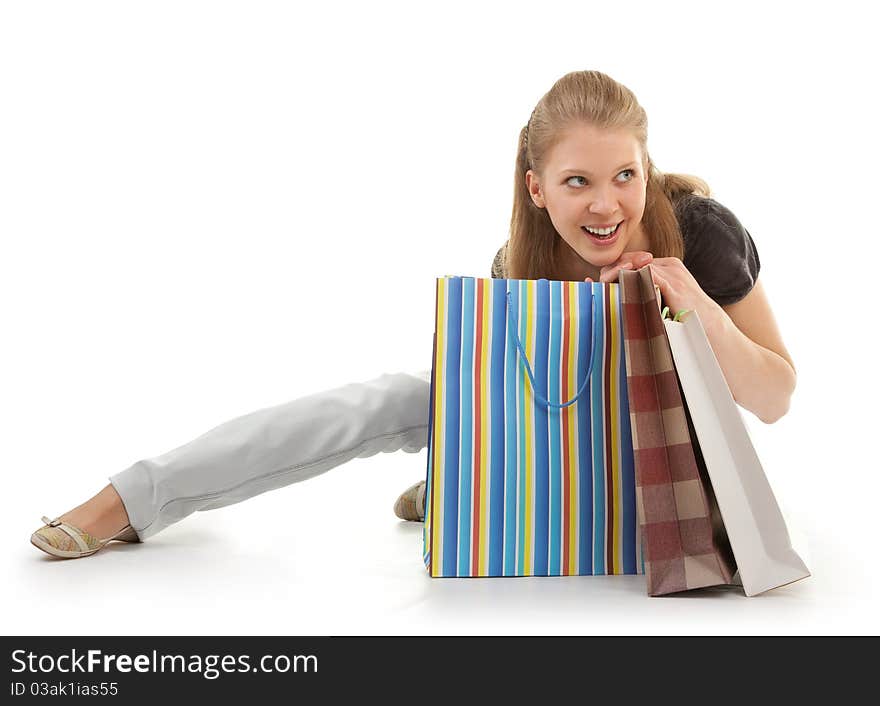 Young girl with purchases on white background