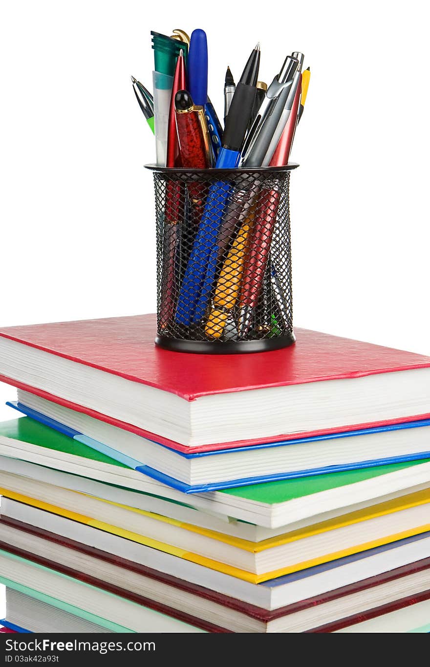 Books and holder basket in pens isolated on white