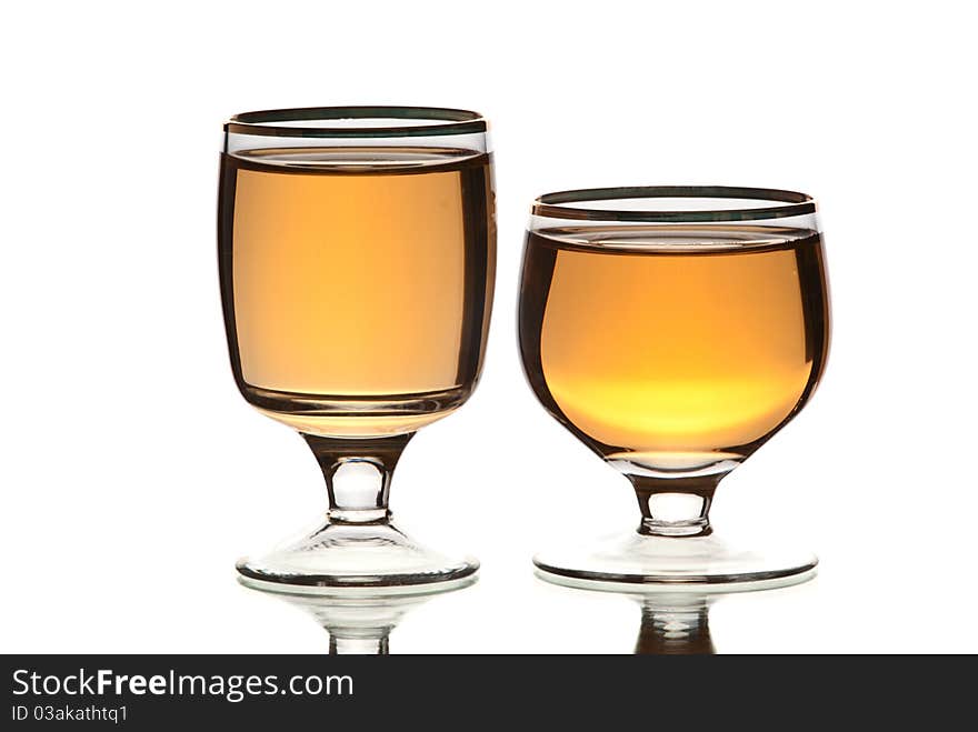 Glasses with alcohol. White background. Studio shot.