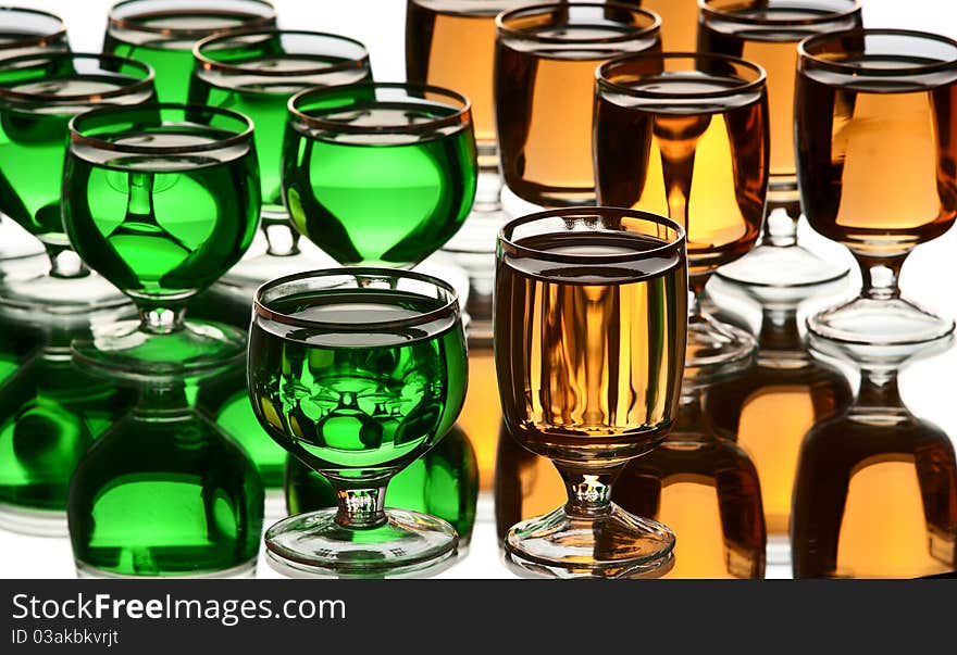 Glasses with alcohol. White background. Studio shot.