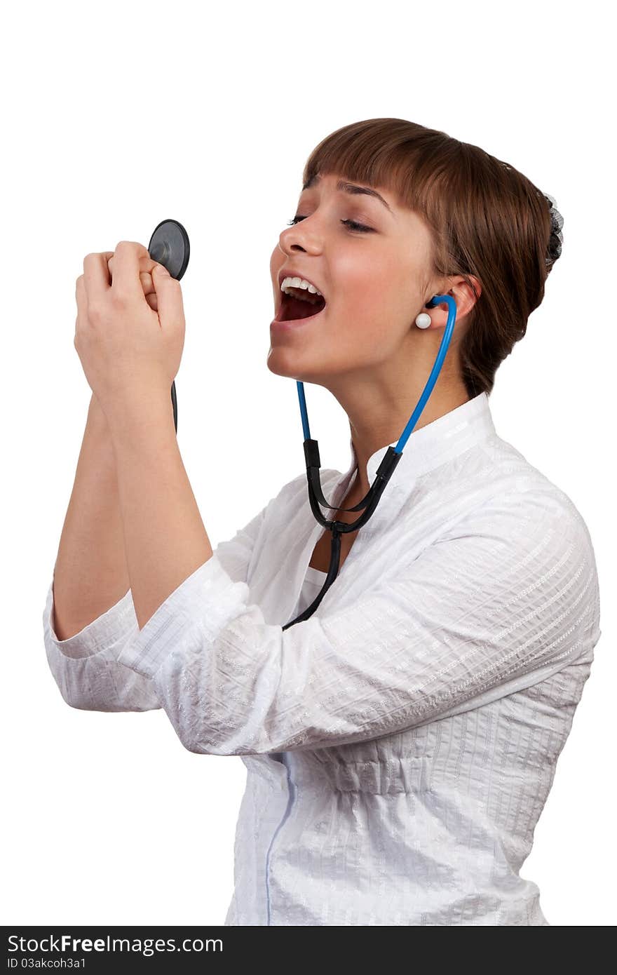 Beautiful young woman doctor with a stethoscope sings on a white background