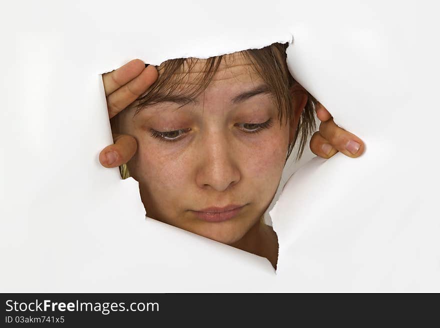 Young Woman is looking out of cutted paper.