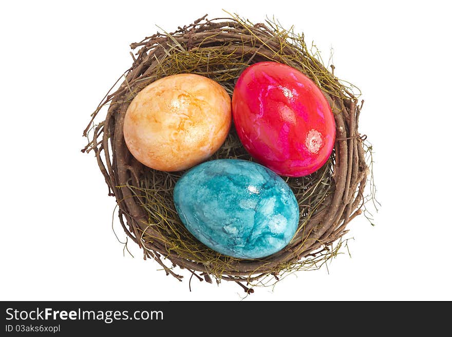 Easter nest with three colored eggs isolated on white background. Easter nest with three colored eggs isolated on white background