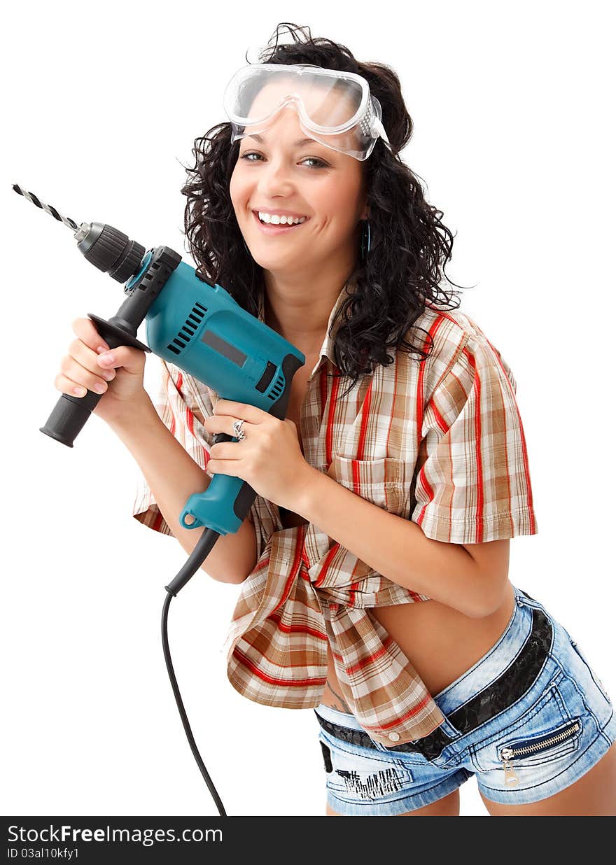 A young smiling female worker with a drilling machine. A young smiling female worker with a drilling machine