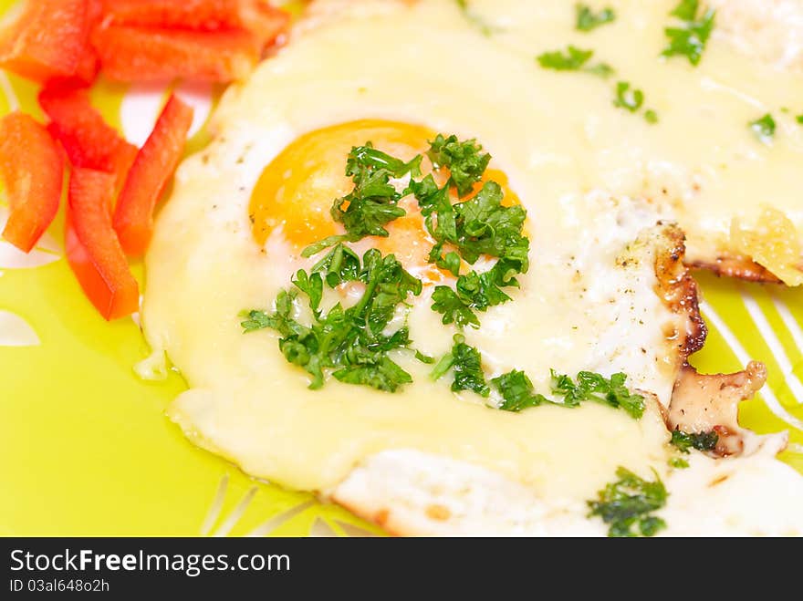 Fried egg with cheese adn red pepper on a plate