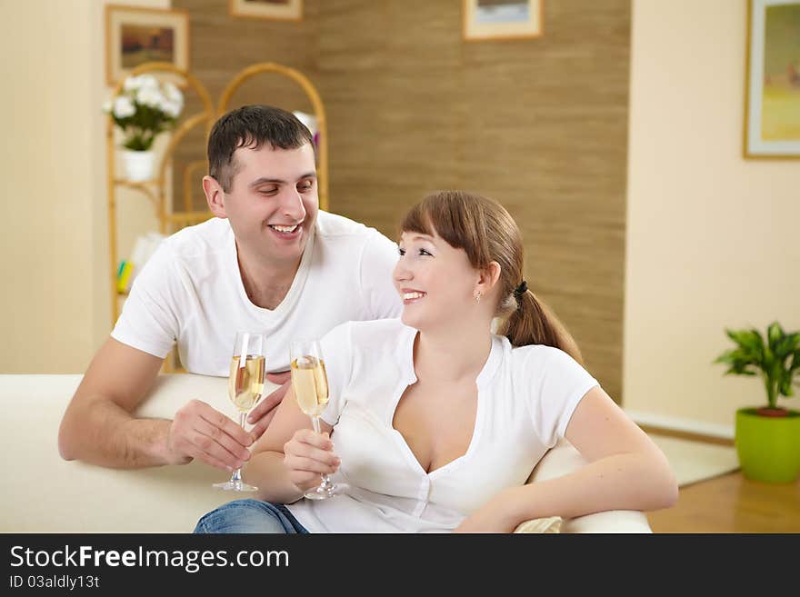 Husband and wife celebrating something at home with glasses of chamagne. Husband and wife celebrating something at home with glasses of chamagne