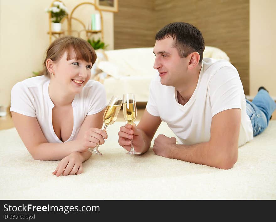 Couple at home drinking champagne