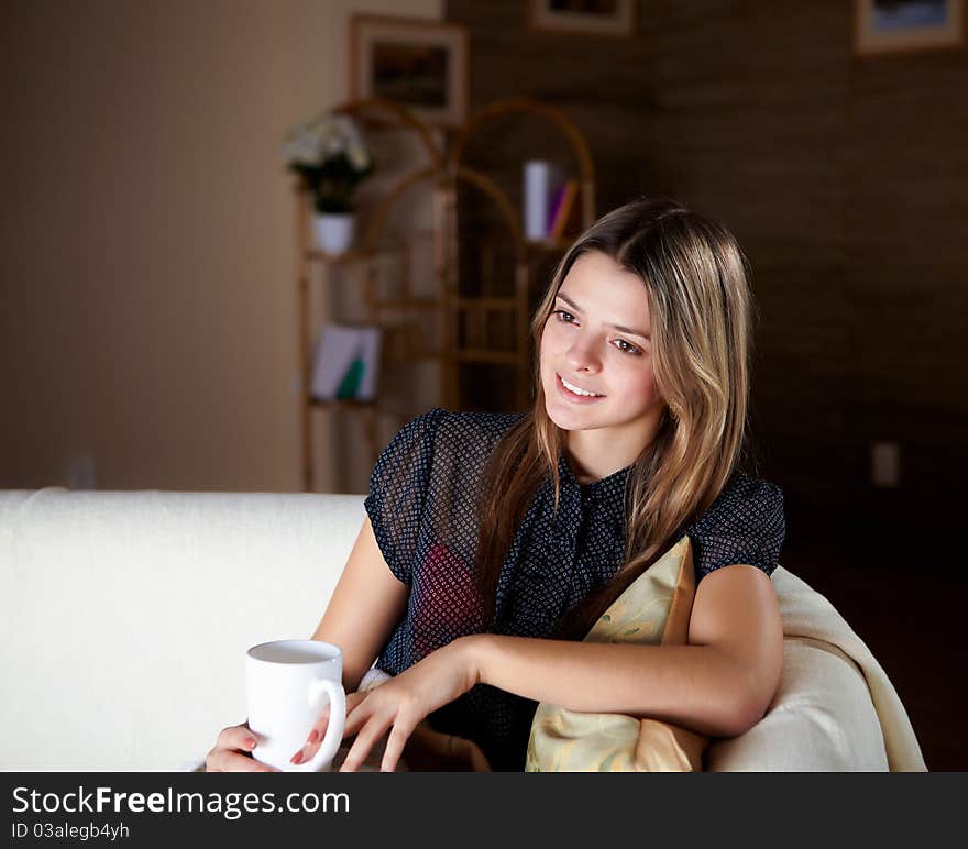 Young Girl Drinking Tea At Home