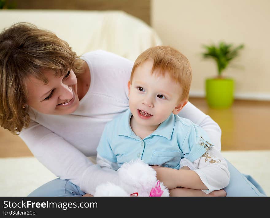 Mother and son at home on the floor