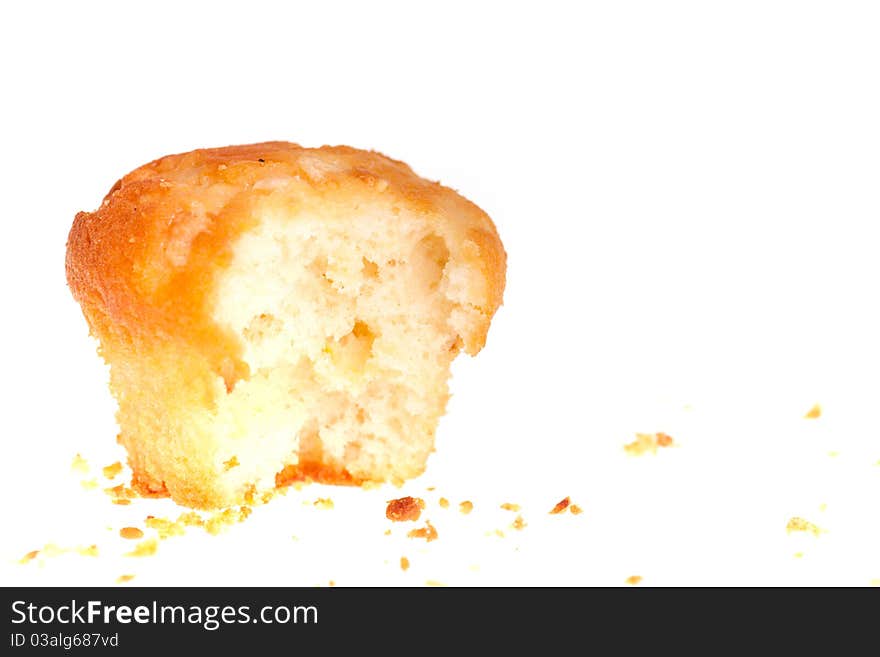 Bitten cup cake on white background.