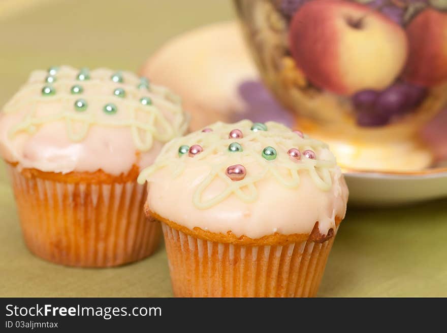 Two green cup cakes on the towel