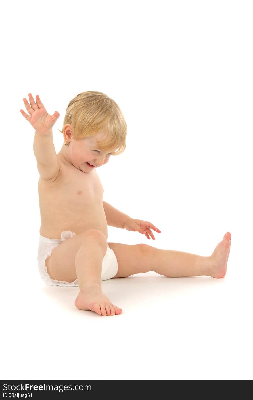 Smiling child sits in nappy, on white background.