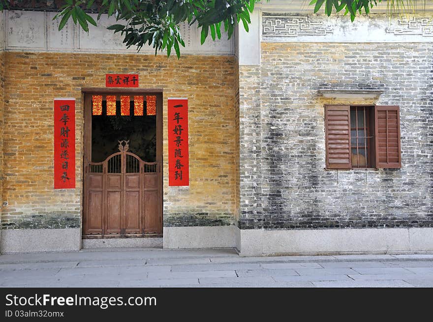 Aged architecture and courtyard in village of Zhongshan city, Guangdong, China. With Chinese traditional style decoration on door, which means lucky and good wishes. Aged architecture and courtyard in village of Zhongshan city, Guangdong, China. With Chinese traditional style decoration on door, which means lucky and good wishes.