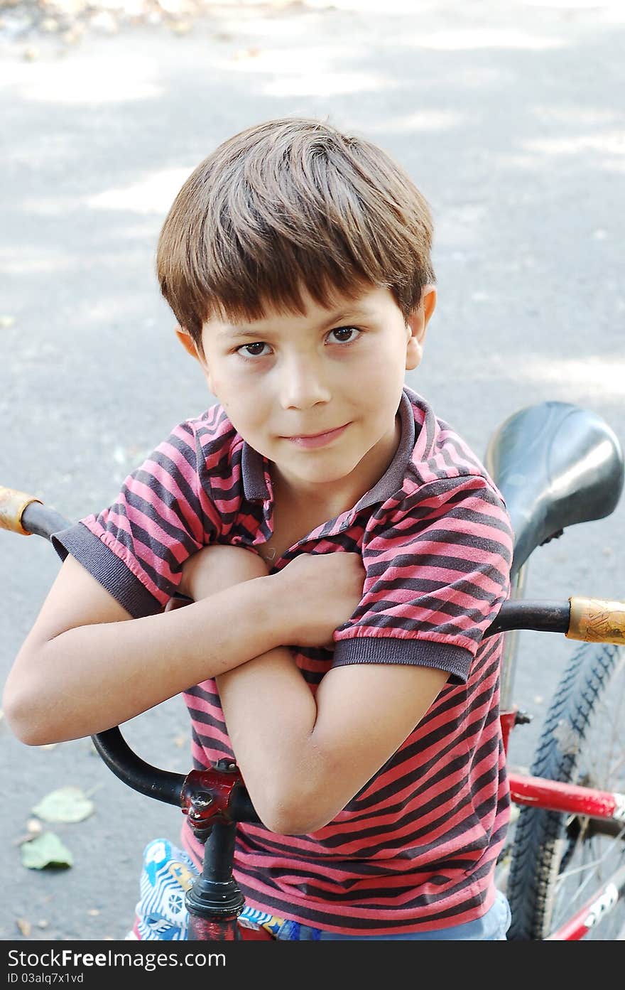 The boy sitting on a bicycle