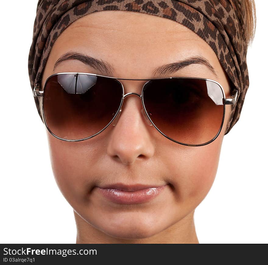 Portrait of a girl with glasses in a leopard scarf on a white background