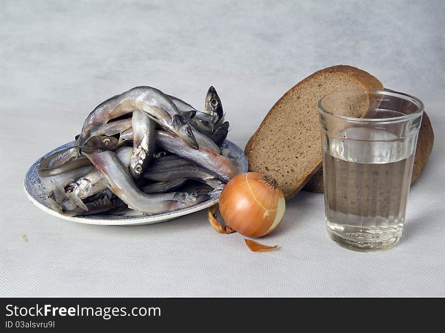 Still life with fish, bread and vegetables on white background