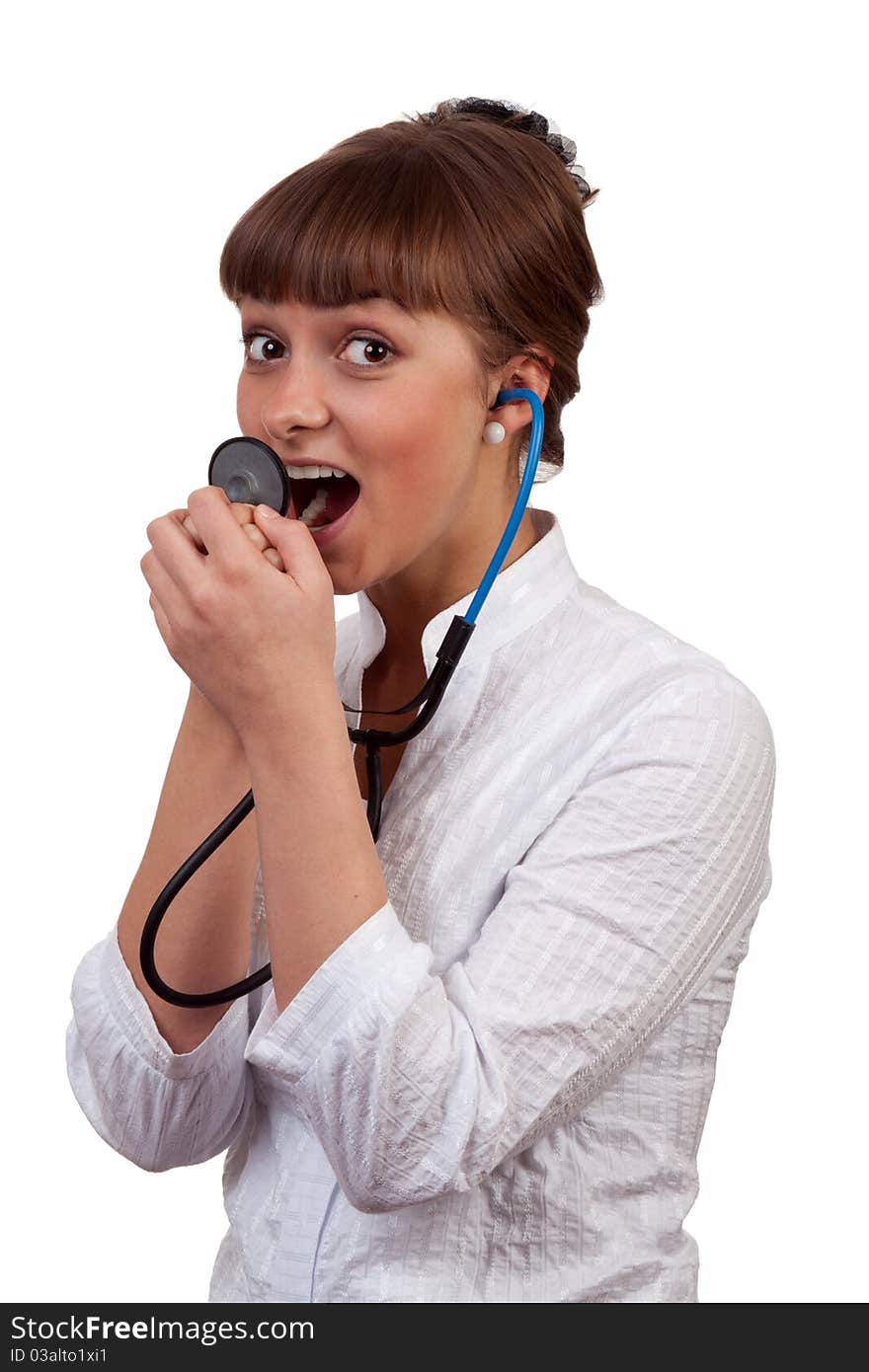 Beautiful young woman doctor with a stethoscope sings on a white background