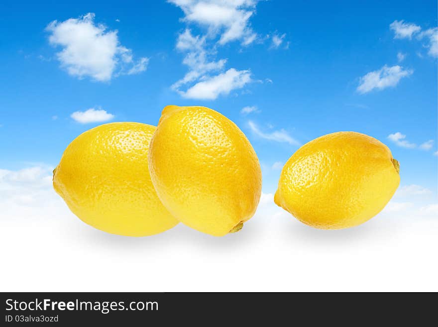 Blue sky with three yellow lemons