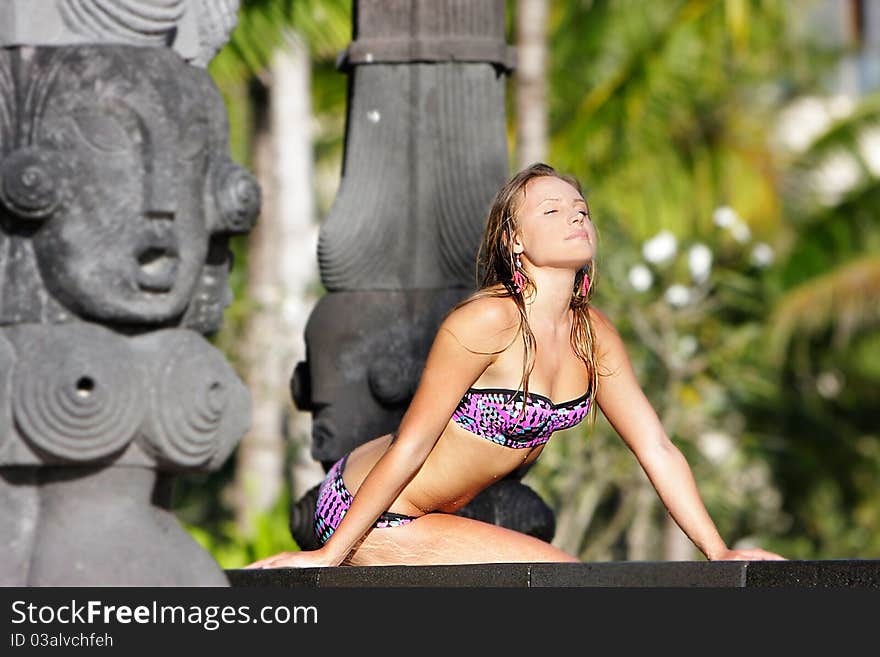 Young beautiful woman relaxing near pool