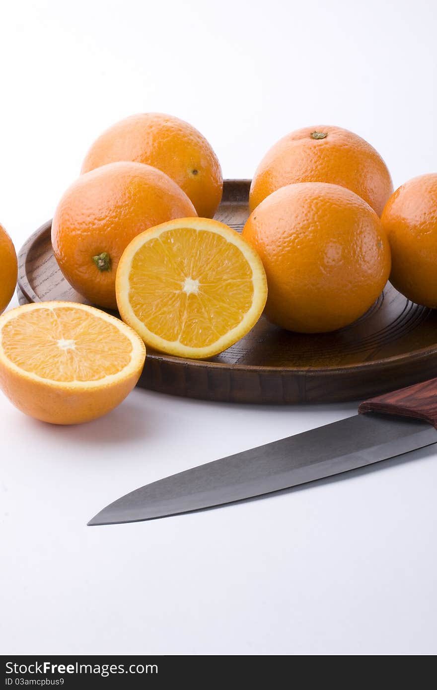 Oranges, wooden tray and a fruit knife