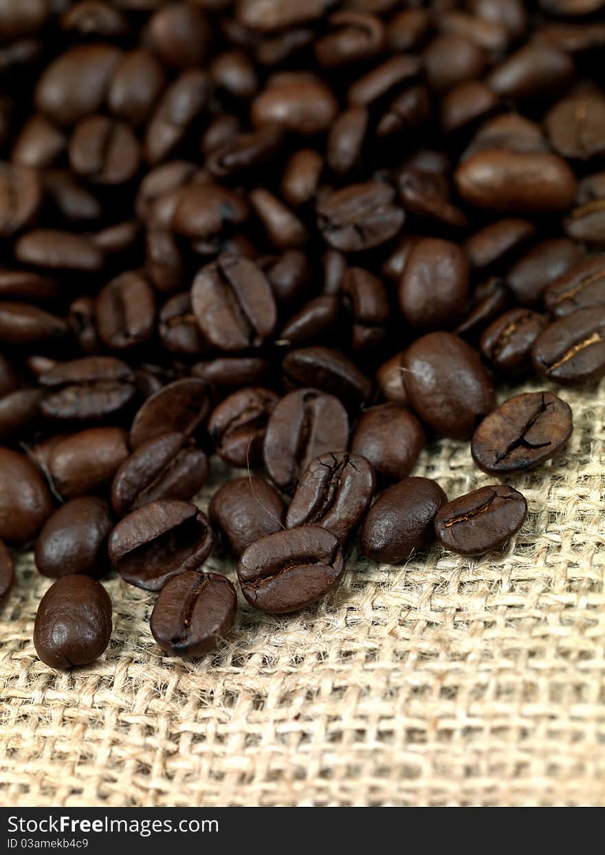 Fresh coffee beans on brown hessian bags