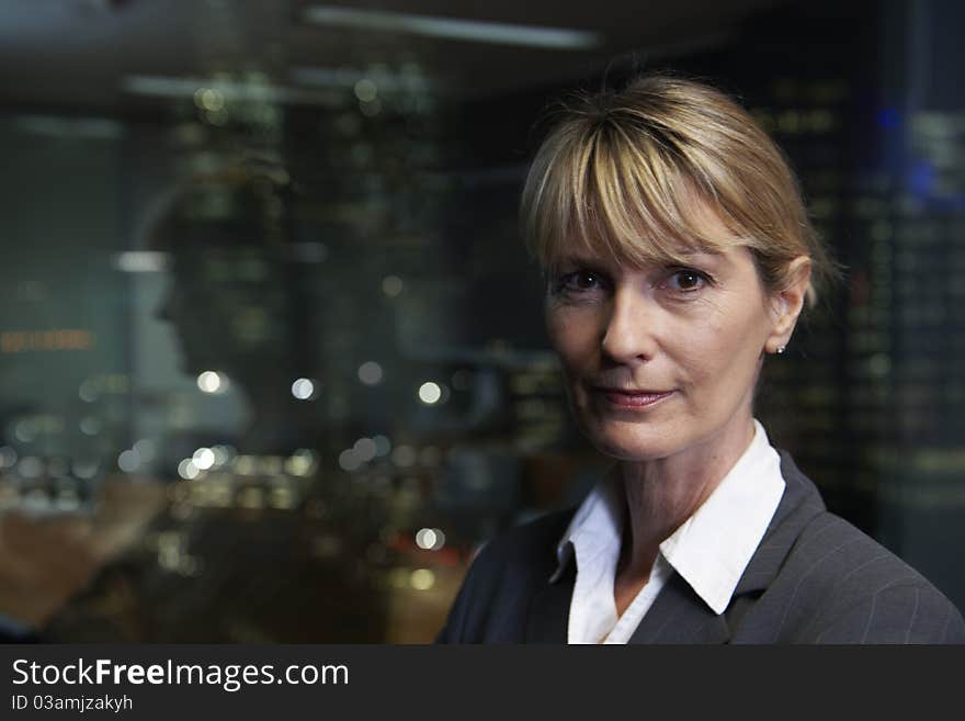 Portrait of a senior executive by a window looking at camera. Portrait of a senior executive by a window looking at camera