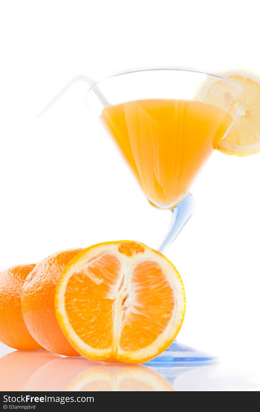 Wine glass of orange juice and fruit on a white background. Wine glass of orange juice and fruit on a white background